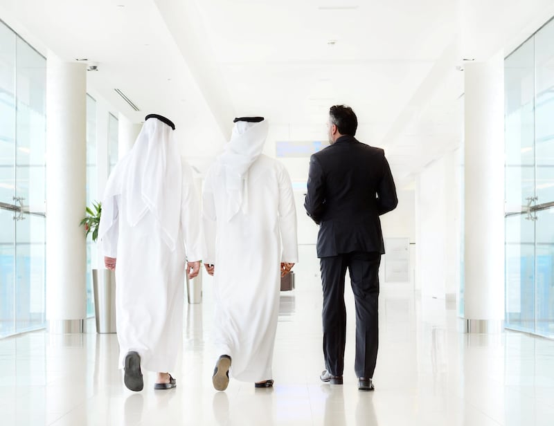 Three arab business men walking, meeting