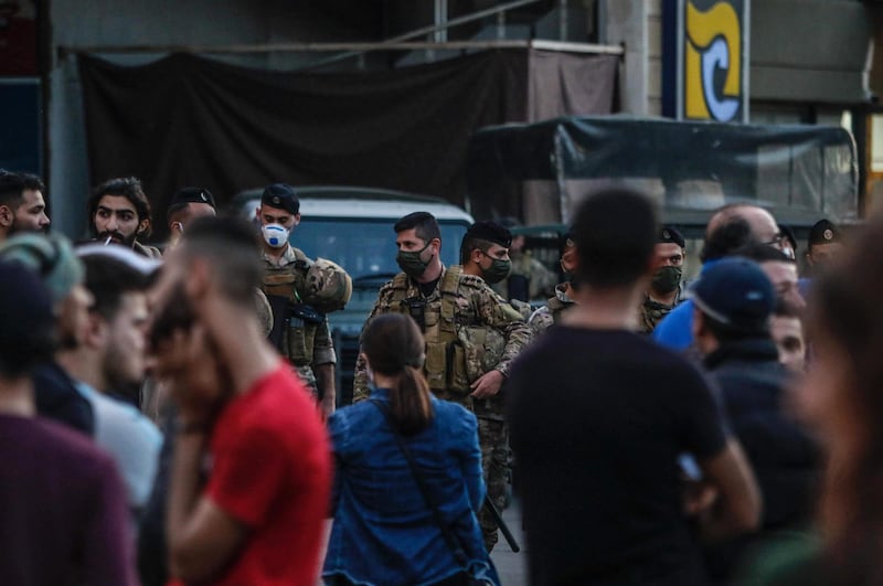 Lebanese soldier wearing masks keep watch as people protest in the northern city of Tripoli on April 17, 2020 despite the country's coronavirus lockdown. AFP