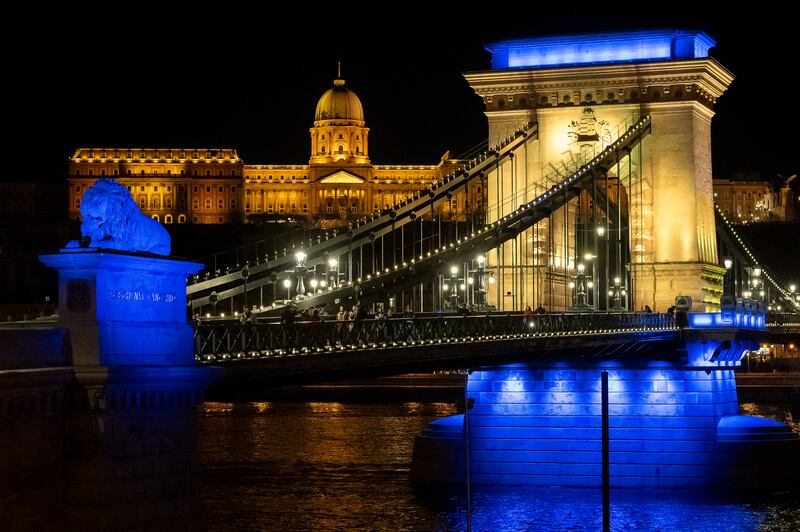 The Chain Bridge is illuminated with the colours of Ukraine to mark the second anniversary of Russia's invasion of the country in Budapest, Hungary. AFP
