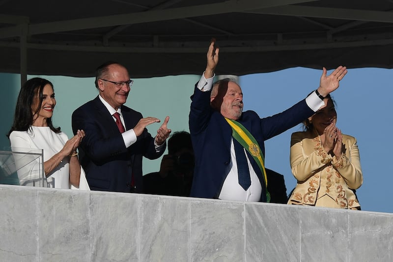 Brazil's new President Luiz Inacio Lula da Silva acknowledges supporters, alongside Vice President Geraldo Alckmin, first lady Rosangela da Silva, right, and Mr Alckmin's wife, Maria Lucia Ribeiro Alckmin. AFP