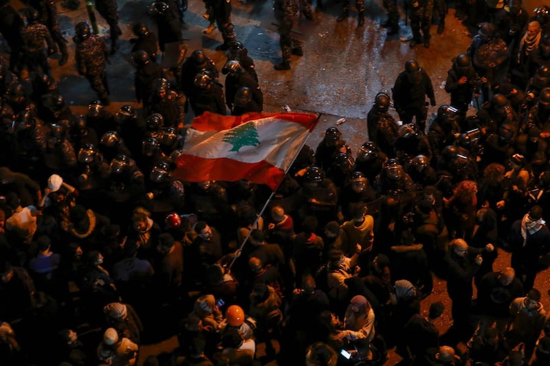 Protesters gather at the entrance of a police barracks housing the detainees who were arrested overnight, in Beirut. AFP
