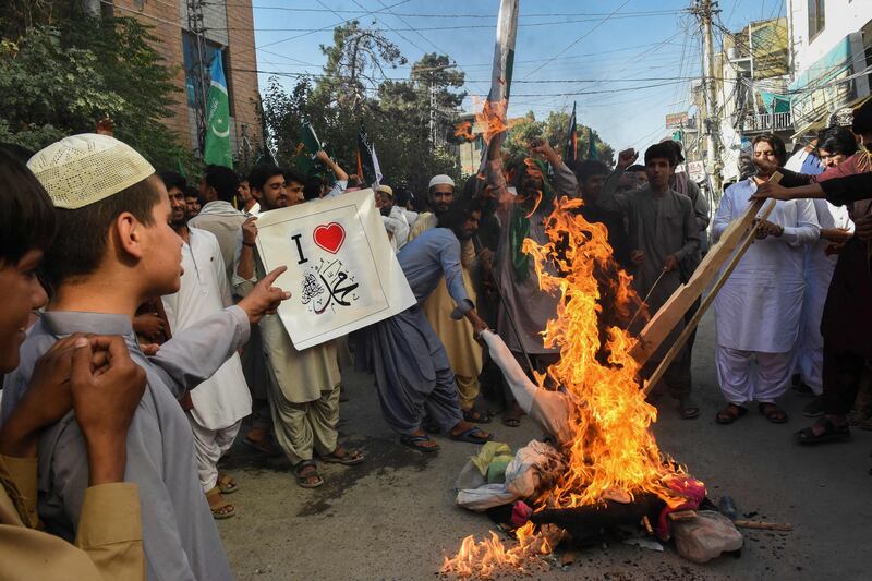 Demonstrators burn an effigy of India's Prime Minister Narendra Modi. AFP