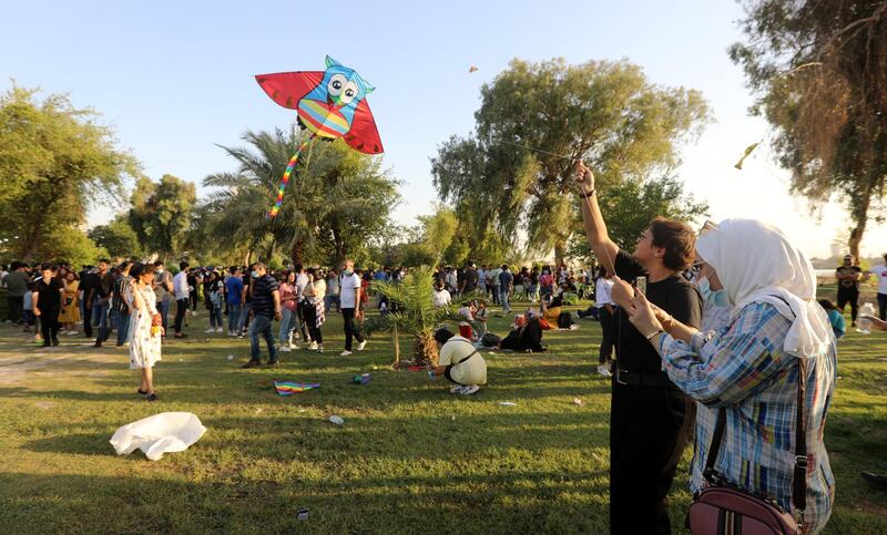 A woman flies a kite as another captures the moment on camera.  EPA