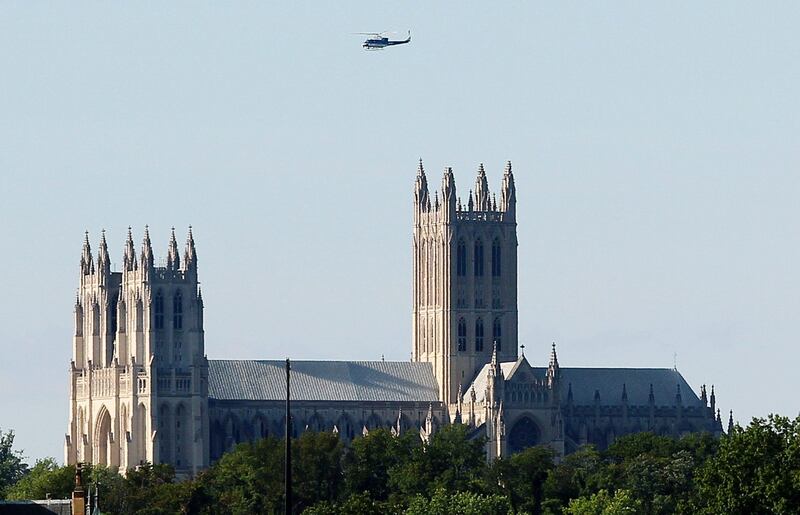 ARLINGTON, VA - AUGUST 23: A helicopter circles the Washington National Cathedral on August 23, 2011 in Arlington, Virginia. According to reports the church suffered minor damage to several spires. The epicenter of the 5.8 earthquake was located in near Louisa in central Virginia.   Mark Wilson/Getty Images/AFP== FOR NEWSPAPERS, INTERNET, TELCOS & TELEVISION USE ONLY ==
 *** Local Caption ***  667085-01-09.jpg