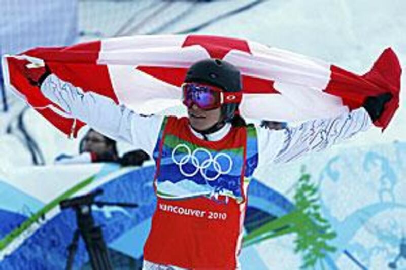 Maelle Ricker, the Canadian snowboarder, celebrates after crossing the finish line.