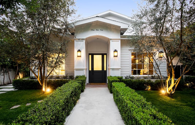 The home has an understated white facade. Courtesy Engel & Volkers