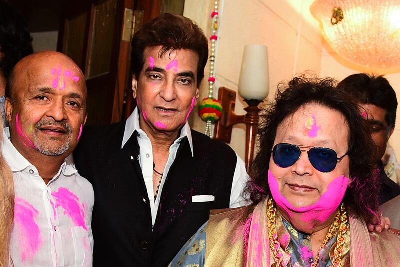 In this picture taken on March 9, 2020, Bollywood lyricist Sameer Anjaan (L), actor Jeetendra (C) and music  composer/singer Bappi Lahiri pose as they celebrate the Holi festival in Mumbai. AFP
