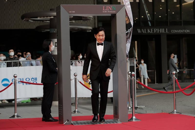 South Korean actor Ahn Sung-ki walks through a thermal camera system to check his body temperature. AP