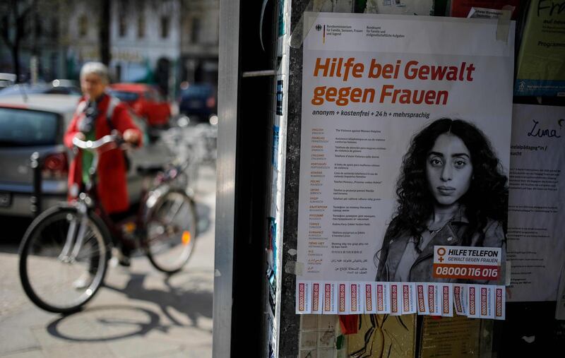 A poster at a shop entrance in Berlin on April 7 advertises the phone number of a helpline for violence against women. With families confined to their homes to curb the spread of the novel coronavirus, fears are rising of a surge in cases of domestic violence. AFP