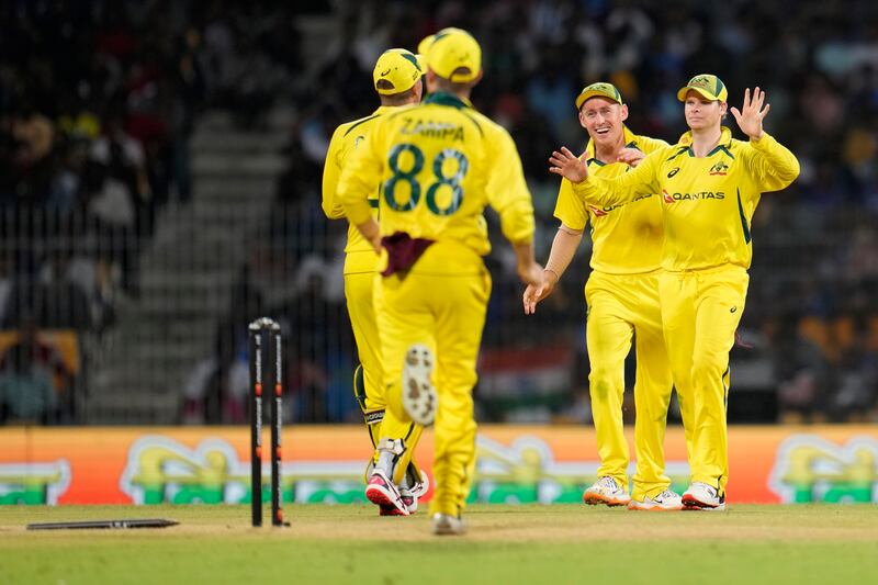 Australia captain Steven Smith, right, after running-out India's Axar Patel for two. AP