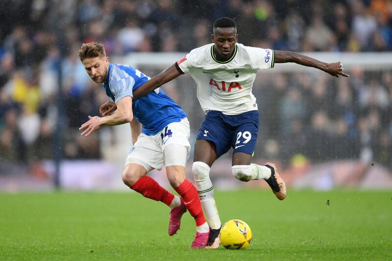 Pape Matar Sarr of Tottenham battles for possession with Michael Jacobs of Portsmouth. Getty