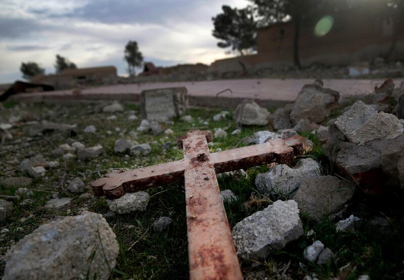 A cross that lies in the rubble of a destroyed church that was blown up by Islamic State militants  in the deserted village of Tal Jazeera, northern Syria. The Qatar-based Syrian Network for Human Rights, a Syrian war monitor associated with the opposition said in its report, that over 120 Christian places of worship have been damaged or destroyed by all sides in the country’s eight-year conflict.  AP