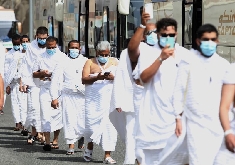 Muslim pilgrims enter Namira Mosque in Arafat, as they wear masks and keep social distance to protect themselves against the coronavirus. AP Photo