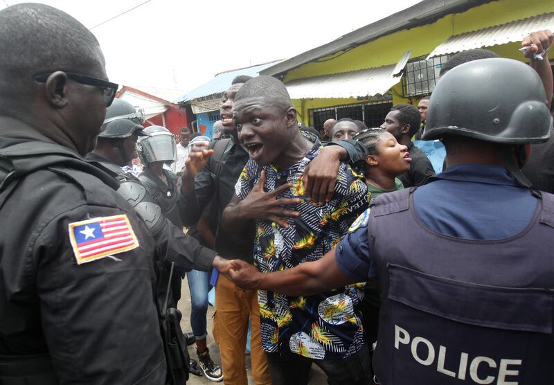 Liberians stage a rally for justice in front of the National Police headquarters in Monrovia. There has been reported rise in mysterious deaths and mob justice incidents in the country.  EPA