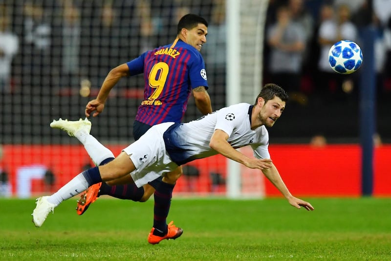 Tottenham Hotspur's Ben Davies in action with Barcelona's Luis Suarez. Reuters