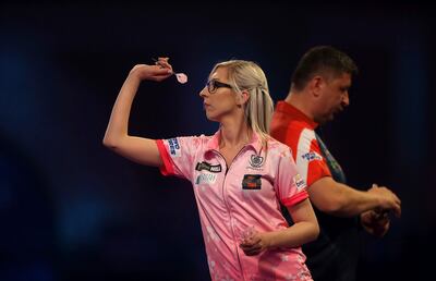 Fallon Sherrock and Mensur Suljovic in action during day nine of the William Hill World Championships at Alexandra Palace, London, Saturday Dec. 21, 2019. (Steven Paston/PA via AP)