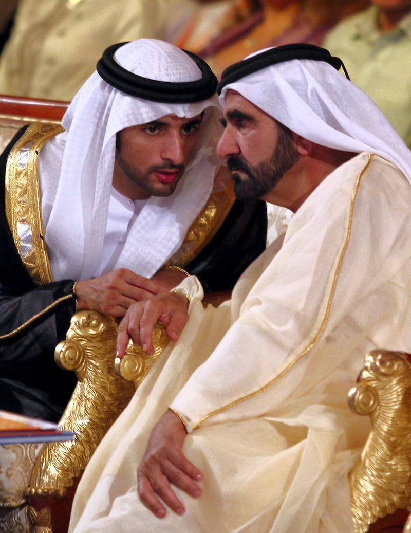 Sheikh Mohammed bin Rashid al-Maktoum, prime minister of the United Arab Emirates and the ruler of Dubai, speaks with his son Sheikh Hamdan bin Mohammed bin Rashid al Maktoum (L) during the opening session of Arab Media Forum in Dubai, on May 17, 2011. AFP PHOTO/Karim SAHIB (Photo by KARIM SAHIB / AFP)