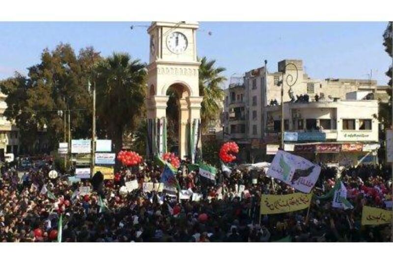 Demonstrators protest against Syria's President Bashar Al Assad after Friday prayers in Idlib.