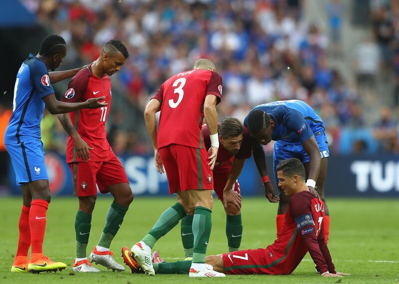 PARIS, FRANCE - JULY 10:  Cristiano Ronaldo of Portugal lies injured during the UEFA EURO 2016 Final match between Portugal and France at Stade de France on July 10, 2016 in Paris, France.  (Photo by Lars Baron/Getty Images)