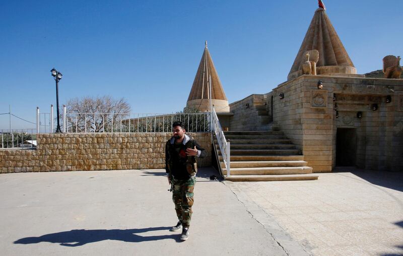 A Yazidi fighter walks near Yazidi temple Sharaf Al Din, in Sinjar. Reuters, file