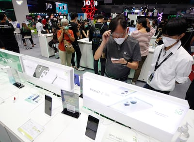 A customer examines Oppo mobile phones at the Thailand Mobile Expo in Bangkok. EPA