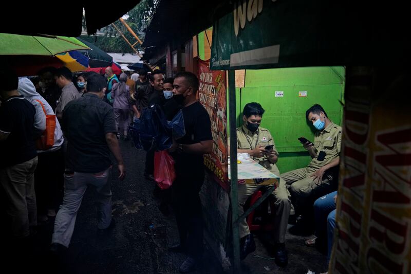 People wait to break their fast at a food stall, during the first week of Ramadan, in Jakarta, Indonesia. AP