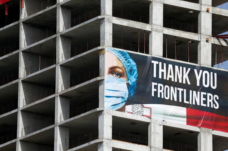 A banner thanking frontline health workers hangs on a high-rise building construction site in St Julian's, Malta. REUTERS