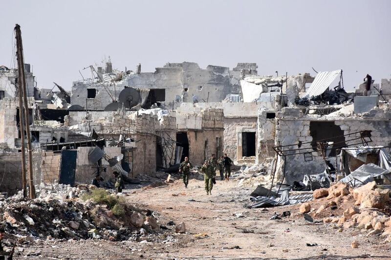 Syrian pro-government forces walk around in the village of Minyan, west of Aleppo, after they retook the area from rebel fighters on November 12, 2016. George Ourfalian / AFP