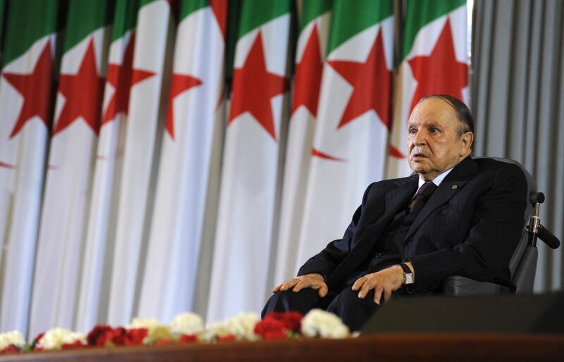 FILE - In this April 28, 2014 file photo, Algerian President Abdelaziz Bouteflika sits on a wheelchair after taking the oath as President, in Algiers. Algeria's longtime leader Bouteflika has abandoned his bid for election to a fifth term in office, but has simultaneously postponed the election set for next month.(AP Photo/Sidali Djarboub, File)