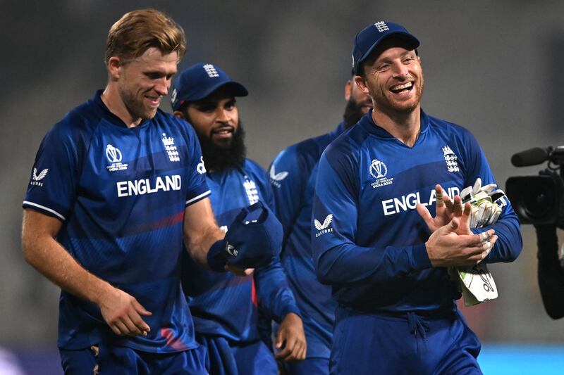 England Jos Buttler, right, leads his team off the field after victory over Pakistan. AFP