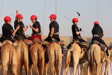 Female participants prepare to compete during the first Female Camel Racing Series C1 Championship at Al Marmoom Camel Racing Track in Gulf emirate of Dubai, United Arab Emirate, 22 October 2021.  Eight female participants took part in the race, seven of them got a training riding course at the school of Arabian Desert Camel Riding Centre (ADCRC) which is the first of its kind in the region, the first center dedicated to teaching camel riding and especially for women.   EPA / ALI HAIDER