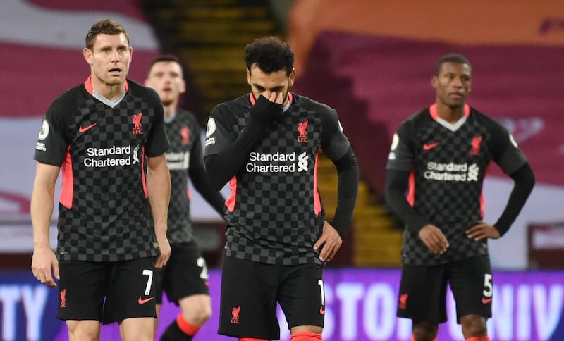 Mohamed Salah, centre, and James Milner, left, look dejected after conceding the seventh goal at Villa. Reuters