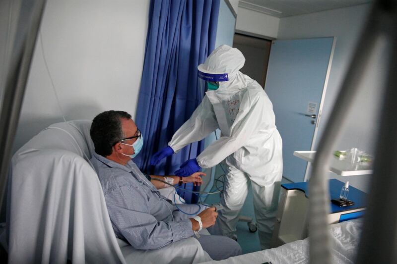 A nurse checks a patient in the Covid-19 ward of Cascais Hospital, Portugal. Reuters