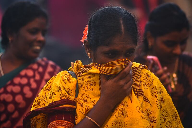 A woman covers her face on a crowded street in Chennai, India, on Tuesday, amid a spike in Covid-19 cases. EPA
