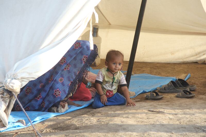 A child displaced by flooding living in a tent city in Hyderabad district, Sindh province, south-east Pakistan. More than 33 million people have been affected nationwide. EPA