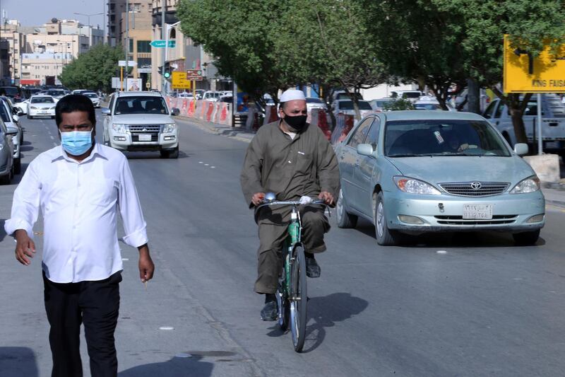 People wearing protective masks are seen in the street, after the government lifted coronavirus disease (COVID-19) lockdown restrictions, in Riyadh, Saudi Arabia July 5, 2020.  REUTERS/Ahmed Yosri