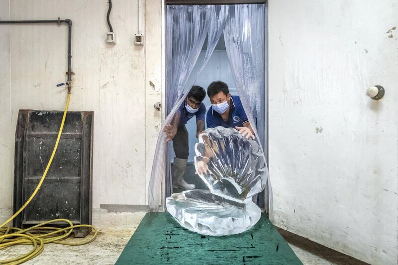 PHOTO PROJECT: ICE FACTORY. A visit to the Gulf Ice Factory & Modern Ice Factory (G&M Ice) located in Dubai Investment Park on June 15th, 2021. The manufacturing of Crystal Clear Ice Blocks whereby a  100cm x 60 cm x 30 cm, 200 kg perfectly clear block of ice is produced over the course of a week. This is accomplished by keeping the water in motion using air while it is slowly frozen. This causes the forming ice to form without traping air inside itself, giving it a clear see through finish that is then used to creat ice sculptures. These ice sculptures can anywhere from 6-12 days before fully melted. They are kept in seperate refrigiration rooms that are set to -18C.
The company first started producing ice in the UAE in 1976 in the emirate of Sharjah followed by setting up of multiple units like Modern Ice Factory in 1989, Quality Ice Distribution Office in 1992, Tube Ice Production in 2000 & its latest production facility at Dubai Investments Park launched in May 2008. They are the largest ice producer in the UAE. 
Antonie Robertson / The National.
Reporter: Antonie Robertson for National