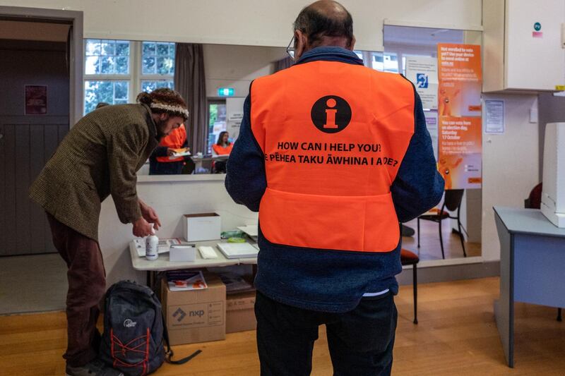 A voter applies hand sanitizer before casting his vote at the Aro Valley Community Centre polling station during the New Zealand General Election in Wellington, New Zealand. Bloomberg