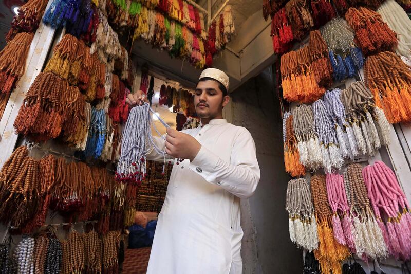 A vendor sells prayer beads at a shop, ahead of Ramadan, in Peshawar, Pakistan.  EPA