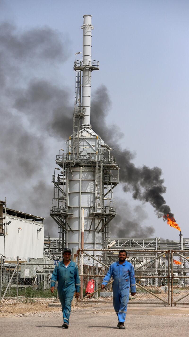 Workers walk at Iraq's Majnoon oilfield near Basra, Iraq, March 31, 2021. Picture taken March 31, 2021.  REUTERS/Essam Al-Sudani