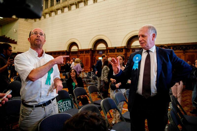 A Green Party candidate argues with a Brexit Party candidate after the European Parliament election results for the UK South East Region are announced at the Civic Centre, Southampton. AFP