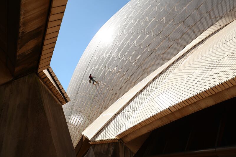 Building operations staff inspect tiles on the Sydney Opera House sails, in Sydney, Austraiia, Getty Images