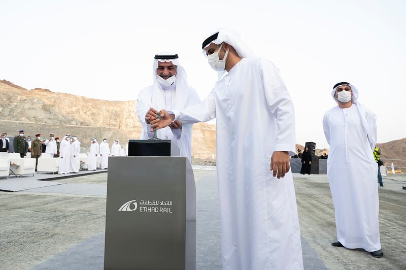 Sheikh Hamad bin Mohammed and Sheikh Theyab bin Mohamed together pull a lever to reveal the completed tunnel.