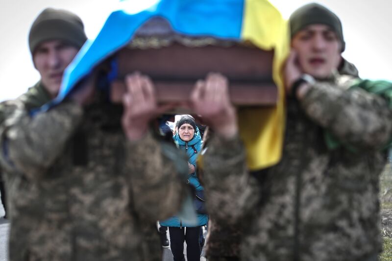 Ukrainian soldiers carry a coffin during the funeral ceremony of a comrade in Odesa. EPA