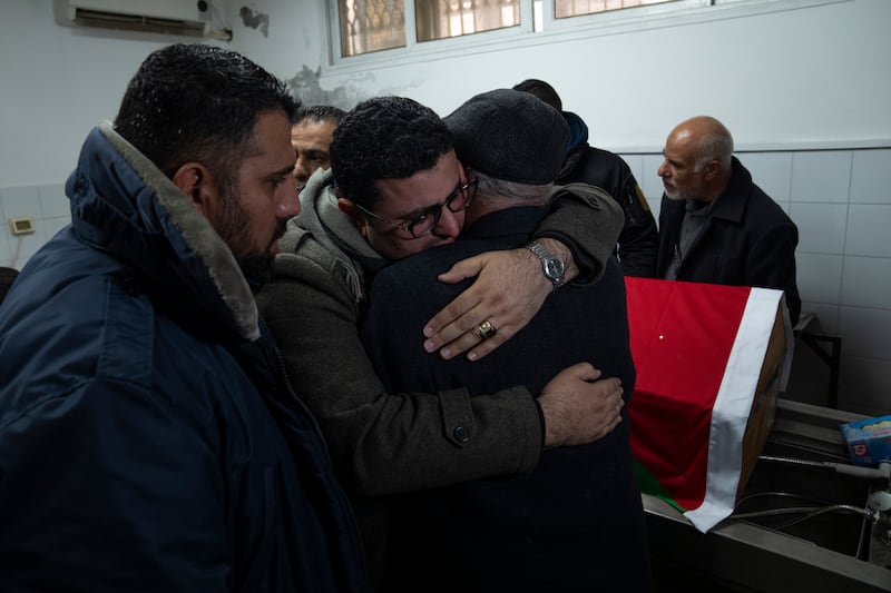 Relatives of Palestinian doctor Yusuf Darabeh, who died when the earthquake hit Turkey, comfort each other. AP Photo