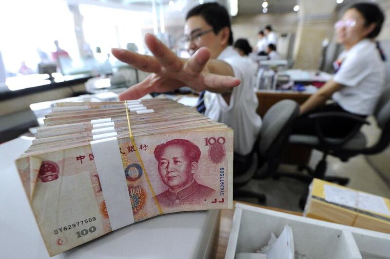 Trade between the UAE and China conducted in the yuan rose 79 per cent last year to 340 million yuan, according to Chinese government data. Above, an employee prepares a bundle of yuan notes at a bank in China. Reuters