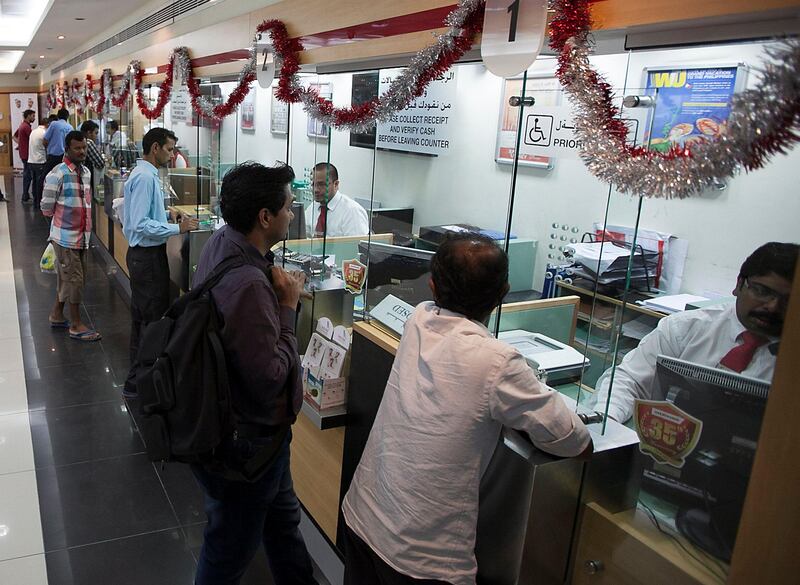 Dubai, United Arab Emirates - November 6, 2015.  Expatriates mostly from the Indian community, sends money to their love one's in India, at the UAE Exchange Centre.  ( Jeffrey E Biteng / The National )  Editor's Note; Amna S reports. *** Local Caption ***  JB061115-Remittances15.jpg