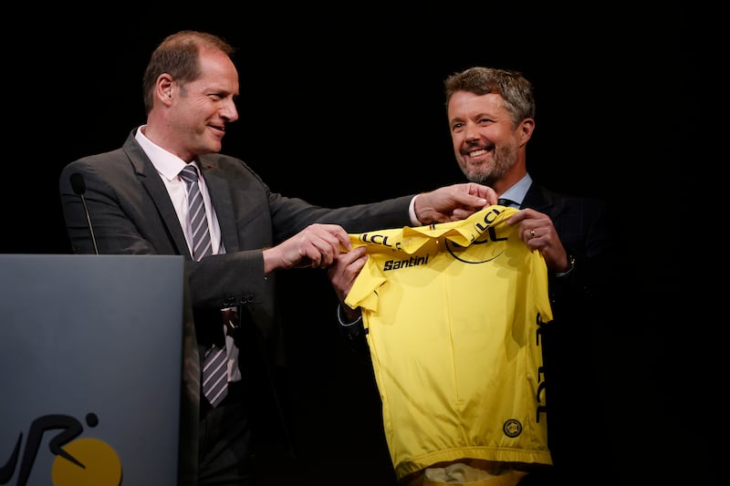 Tour de France general director Christian Prudhomme offers a yellow jersey to Crown Prince Frederik of Denmark. EPA