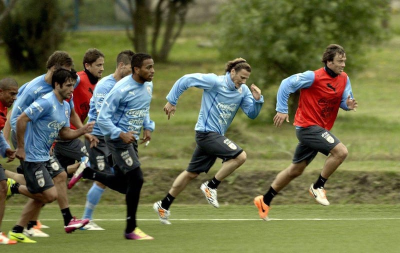 Diego Lugano, right, and Diego Forlan, second right, with Uruguay shown training on May 21, 2014. Matilde Campodonico / AP