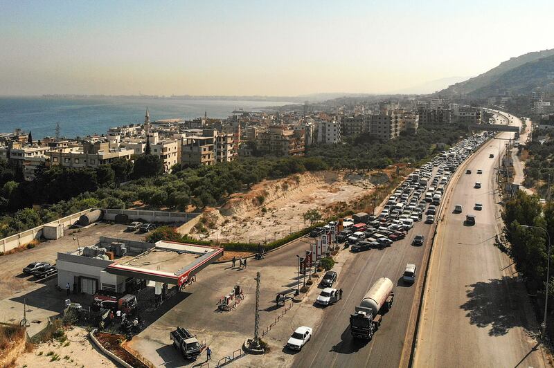 An aerial view shows vehicles queueing for fuel as traffic flows through on the Tripoli-Beirut highway in the coastal city of Qalamun in northern Lebanon.